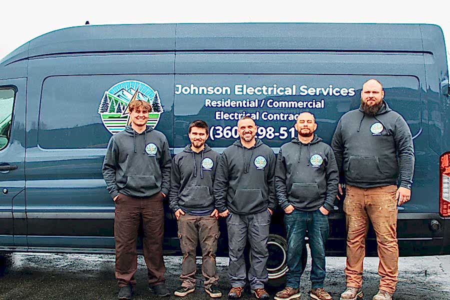 electrical-service-team-1 Johnson Electrical Services team standing in front of their service van in Mount Vernon, WA.
