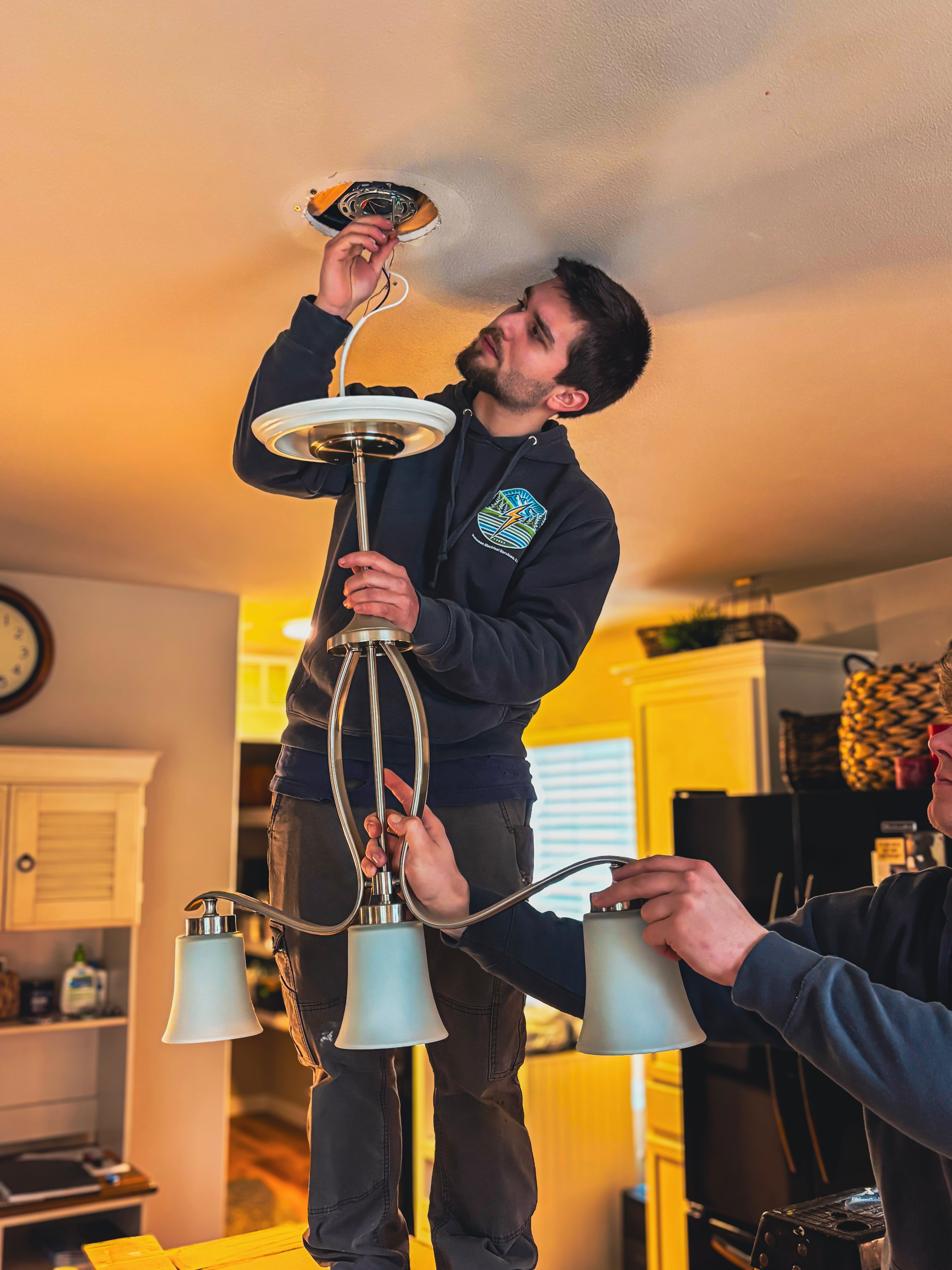 modern-light-fixture-installation-burlington-wa Licensed electrician installing new light fixtures in Skagit County, WA, improving home lighting, functionality, and visual appeal.