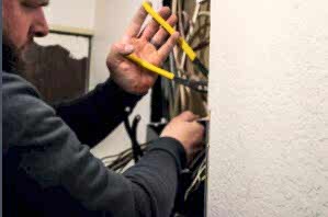Electrician working on an electrical panel.