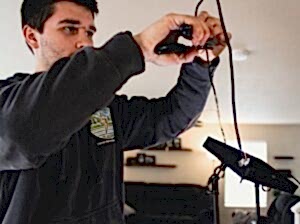 Electrician performing an electrical inspection inside a home in Arlington, WA.
