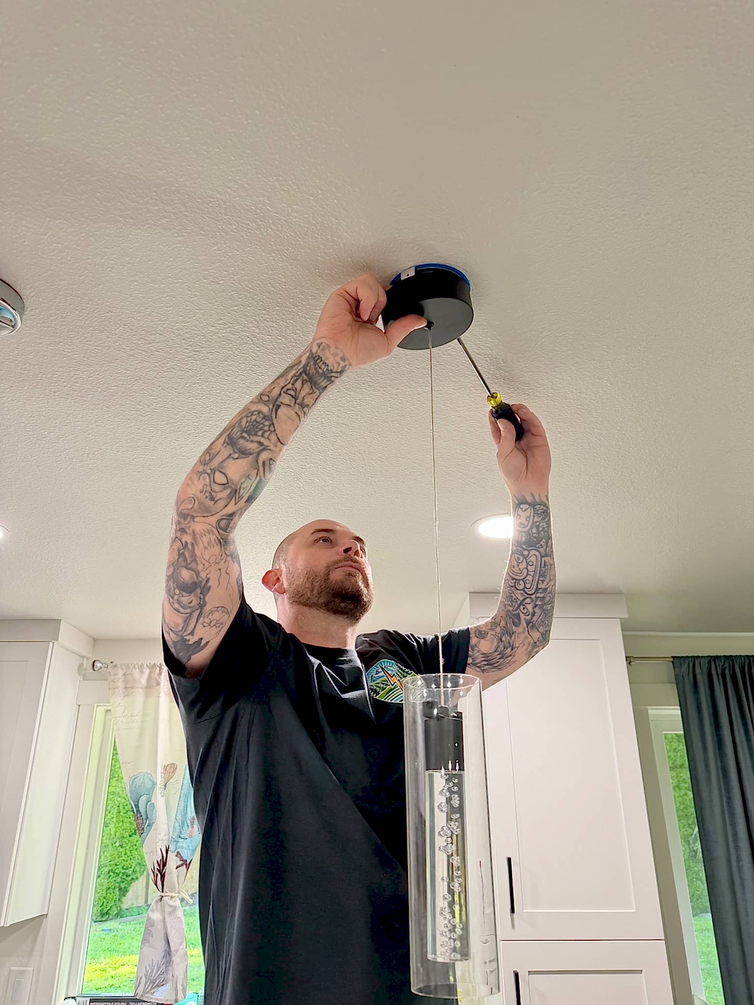 marysville-wa-lighting-installation-johnson-electrical-services Johnson Electrical Services electrician installing a ceiling light fixture in a Marysville, WA home.